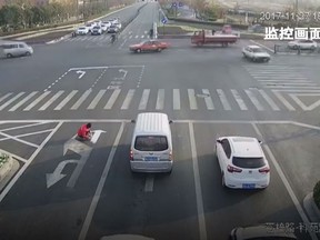 A Chinese man has been fined US$150 after being caught painting over road direction arrows to make his bus commute faster. (YouTube/CGTN)