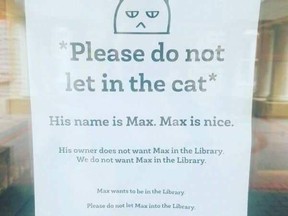 A poster in the window of Macalester College library in St. Paul, MN asks patrons not to let in Max the cat.