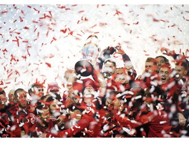 Toronto FC midfielder Michael Bradley, centre, hoists the MLS Cup with teammates after defeating the Seattle Sounders during MLS Cup soccer action in Toronto on Saturday, December 9, 2017.