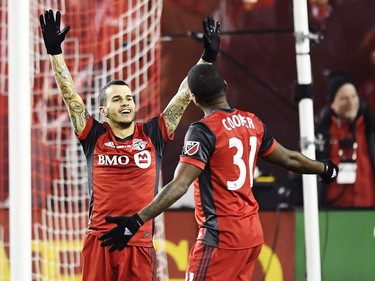 Toronto FC forward Sebastian Giovinco (10) and Armando Cooper celebrate after defeating the Seattle Sounders in MLS Cup Final soccer action in Toronto on Saturday, December 9, 2017.