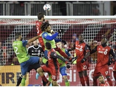 Toronto FC defender Drew Moor (3) and Seattle Sounders defender Roman Torres (29) go up for the ball in the box during second half MLS Cup Final soccer action in Toronto on Saturday, December 9, 2017.