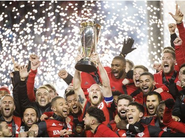 Toronto FC midfielder Michael Bradley, centre, hoists the MLS Cup with teammates after defeating the Seattle Sounders during MLS Cup soccer action in Toronto on Saturday, December 9, 2017.