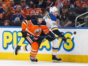 Edmonton Oilers defenceman Kris Russell (left) skates against the St. Louis Blues on Dec. 21.