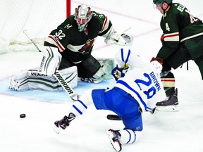 Minnesota Wild goalie Alex Stalock (32) blocks a shot by former Marlies teammate Connor Brown of the Leafs as defenceman Mike Reilly looks on during the third period of an NHL hockey game Thursday, Dec. 14, 2017, in St. Paul, Minn. The Wild won 2-0. (AP Photo/Hannah Foslien)