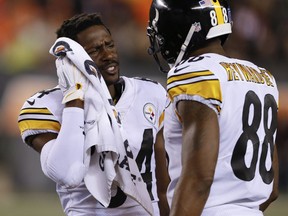 Pittsburgh Steelers wide receiver Antonio Brown, left, speaks with wide receiver Darrius Heyward-Bey (88) on the sidelines in the first half of an NFL football game against the Cincinnati Bengals, Monday, Dec. 4, 2017, in Cincinnati.