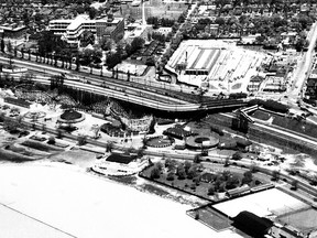 This aerial photograph was taken in 1948 (a date confirmed by the ongoing construction of the Morrow wing at St. Joseph’s Health Centre in the background). In addition to the Sunnyside Amusement Park straddling Lake Shore Blvd., the view captures the TTC’s Roncesvalles car house and The Queensway thoroughfare that at the time the photo was taken ended at Glendale Ave.. just west of the hospital. It would be extended westerly in late 1956. Also visible is the “ancient” bridge that conveyed cars, trucks and streetcars between the old Lakeshore Rd. to the King, Queen, Roncesvalles intersection. The bridge was demolished soon after this photo was taken. Just east of that same intersection is the Sunnyside railway station (demolished) serving passenger trains using the rail corridor that is still in use by GO and VIA. On the water’s edge are the Palais Royale (bottom centre) and the Boulevard Club (lower right).