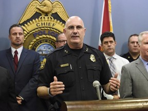 Tampa Police Chief Brian Dugan, center, along with Mayor Bob Buckhorn, right, announce that they intend to charge Howell Emanuel Donaldson, 24, with four counts of first degree murder in connection with the Seminole Heights homicides, Tuesday, Nov. 28, 2017, in Tampa, Fla.