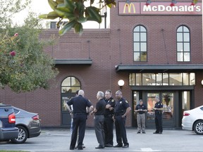 Police investigate at the scene following a lead of a man with a gun at a McDonald's in Ybor City in Tampa, Fla., Tuesday, Nov. 28, 2017.