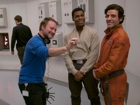 Rian Johnson on the set of "Star Wars: The Last Jedi" with stars John Boyega and Oscar Isaac.