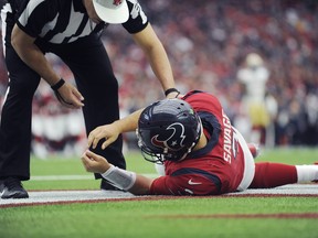 Houston Texans quarterback Tom Savage is checked by a referee after he was hit during the first half of an NFL football game against the San Francisco 49ers, Sunday, Dec. 10, 2017, in Houston. Savage left the game. (AP Photo/Eric Christian Smith)