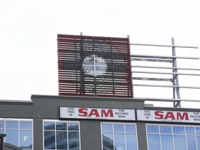 Workmen slowly piece together the old 'Sam The Record Man' sign, which previously adorned the flagship store on Yonge St., atop a building on Dundas St. E. just east of Yonge in Toronto on Friday, December 1, 2017. (Stan Behal/Toronto Sun )