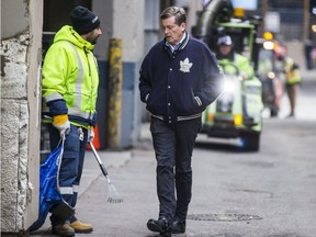 Toronto Mayor John Tory speaks with a city solid waste employee during a walk along O'Keefe Ln. by Yonge St. and Dundas St. E. in Toronto, Ont. on Saturday December 2, 2017. Mayor Tory launches clean sweep blitz for Yonge and Dundas neighbourhood.