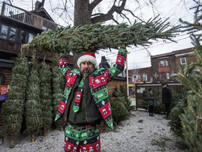 Lot manager Jonathan Howcroft of Sweatpea's Christmas Tree Lot poses for a photo along Roncesvalles Ave. in Toronto, Ont. on Wednesday December 20, 2017. Due to an anonymous complaint, the business was originally forced to clear its remaining 150 trees by the end of the day on Wednesday, Dec. 21 2017. That decision was overruled later in the day.