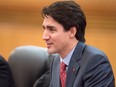 This file photo taken on December 4, 2017 shows Canada's Prime Minister Justin Trudeau speaking to China's Premier Li Keqiang during a meeting at the Great Hall of the People in Beijing.