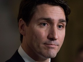 Prime Minister Justin Trudeau speaks with the media in the foyer of the House of Commons following the release of an ethics report in Ottawa on Wednesday Dec. 20, 2017. THE CANADIAN PRESS/Adrian Wyld