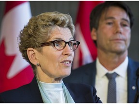 Premier Kathleen Wynne stands with Health Minister Eric Hoskins.