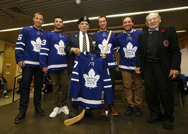 Current and former Toronto Maple Leafs visited Sunnybrook for a belated Remembrance Day ceremony and to meet the veterans there.  Curtis McElhinney, Name Kadri, Dominic Moore, Darcy Tucker and Johnny Bower presented Korean War vet Bill Morgavero, 88, with a signed sweater and stick for Sunnybrook Veterans Wing  on Monday November 13, 2017.  Michael Peake/Toronto Sun