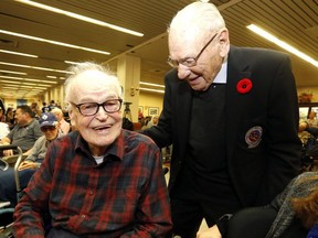 Former Hockey Night in Canada vet Murray Westgate, 99, left, chats with Leafs vet Johnny Bower during the Maple Leafs visit to Sunnybrook Veterans Centre on November 13, 2017.  (Michael Peake/Toronto Sun)