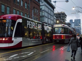 Commuters run towards a TTC stop at Bathurst and King Street West in Toronto on November 13, 2017. Running late due to transit delays in Canada's most populous city? The Toronto Transit Commission can help explain your tardiness. The municipal transit authority offers a little-known service that provides late notes for commuters delayed by its subways, streetcars and buses. THE CANADIAN PRESS/Christopher Katsarov