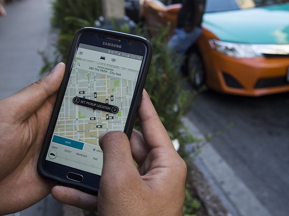  Ordering an Uber with the app on Monday August 8, 2016. (Postmedia Network)