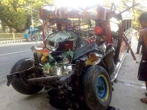 This photo provided by Land Transportation Franchise and Regulatory Board (LTFRB) shows the wreckage of a passenger van in La Union province, Philippines following an early morning collision with a passenger bus Monday, Dec. 25, 2017. (AP Photo/LTFRB via AP)