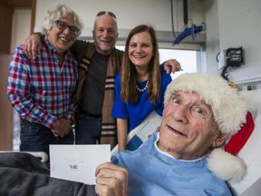 Long time fundraiser Mort Greenberg poses for a photo along with his nephew Sheldon Ehrenworth with his friend Elizabeth Shelton - with Mike Strobel in the middle - from his hospital bed at Bridgepoint in Toronto, Ont. on Friday, Dec. 22, 2017. Greenberg holds an envelope with cheques totalling $11,000 he has raised for the Variety Village Christmas fund.
