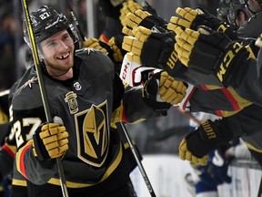 Shea Theodore of the Vegas Golden Knights celebrates with teammates after scoring on a goal against the Tampa Bay Lightning on Dec. 19, 2017