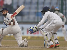 India's captain Virat Kohli plays a sweep shot during a Test match against Sri Lanka in early December. (The Associated Press)