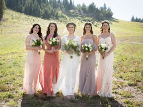 In this Sept. 2, 2017 photo provided by Nisha Louise, Alison Reed, center, of Colorado Springs, Colo., stands with her bridal party in Vail, Colo. Reed chose to allow her bridesemaids leeway in the colors and styles of dresses they wore. Experts say mismatched bridesmaids dresses are a growing trend as more brides personalize their weddings. (Nisha Louise Photography via AP) ORG XMIT: NYLS412 AP PROVIDES ACCESS TO THIS THIRD PARTY PHOTO SOLELY TO ILLUSTRATE NEWS REPORTING OR COMMENTARY ON FACTS DEPICTED IN IMAGE; MUST BE USED WITHIN 14 DAYS FROM TRANSMISSION; NO ARCHIVING; NO LICENSING; MANDATORY CREDIT