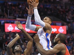 Oklahoma City Thunder's Russell Westbrook goes up for a shot over Toronto Raptors' OG Anunoby and Serge Ibaka on Dec. 27, 2017