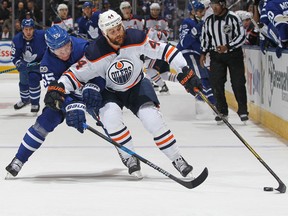Zack Kassian of the Edmonton Oilers skates against Andreas Borgman of the Toronto Maple Leafs on Dec. 10, 2017