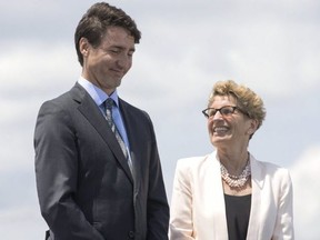 Canadian Prime Minister Justin Trudeau stands alongside Ontario Premier Kathleen Wynne (right) during a funding announcement for the Toronto waterfront in Toronto on Wednesday, June 28 , 2017.