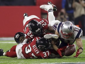 FILE - In this Feb. 5, 2017, file photo, New England Patriots' Julian Edelman (11) makes a catch as Atlanta Falcons' Ricardo Allen and Keanu Neal defend, during the second half of the NFL Super Bowl 51 football game in Houston. (AP Photo/Patrick Semansky, File)