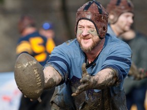 Former Blue Jays catcher Greg Zaun takes part in the 100th Grey Cup Festival Mud Bowl on Nov. 19, 2012.