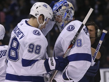 Mikhail Sergachev and Andrei Vasilevskiy celebrate the win