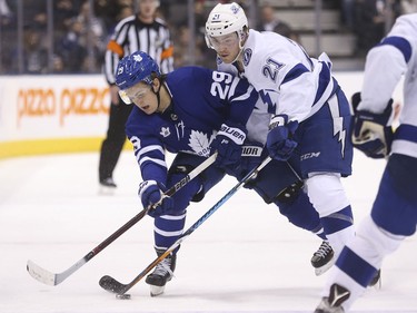 William Nylander dumps the puck into the zone with Brayden Point on his back