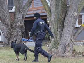 Toronto Police search the grounds at 53 Mallory Cres.