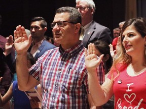 People take the citizenship oath at Pier 21 immigration centre in Halifax on July 1, 2017.