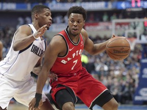 Toronto Raptors guard Kyle Lowry dribbles against Dallas Mavericks guard Dennis Smith Jr.  earlier this season. (THE CANADIAN PRESS)