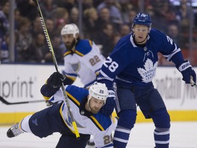 St. Louis Blues  winger Chris Thorburn gets taken down by Leafs winger Connor Brown during Tuesday's game. (STAN BEHAL/Toronto Sun)