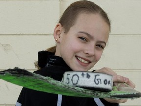 Riley Scorgie, 11, poses for a photo with the puck that she scored her 50th goal this year, prior to a Minor Hockey Week game at Coronation Arena, 13500 112 Avenue, in Edmonton Saturday, Jan. 13, 2018. Photo by David Bloom