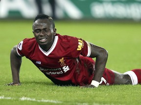 Liverpool's Sadio Mane lays on the pitch during Monday's loss to Swansea. (AP)