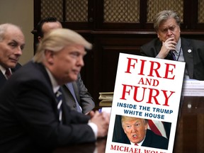 White House Chief Strategist Steve Bannon (R) listens to U.S. President Donald Trump at the beginning of a meeting with government cyber security experts in the Roosevelt Room at the White House January 31, 2017 in Washington, DC.