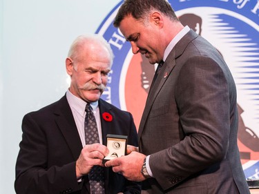Eric Lindros receives his HHOF ring from Lanny McDonald in Toronto on Nov. 11, 2016
