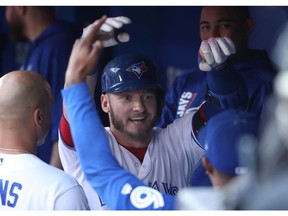 Josh Donaldson is congratulated by Blue Jays teammates in the dugout after hitting a two-run home run against the Tampa Bay Rays at Rogers Centre on Aug. 14, 2017 in Toronto.