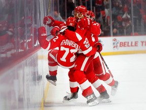 Red Wings forward Andreas Athanasiou is mobbed by teammates after scoring six seconds into OT in a game against the Senators on Jan. 3, 2018