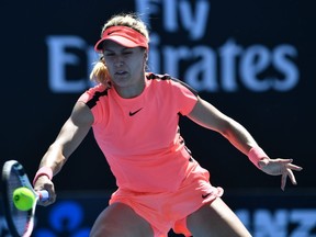 Canada's Eugenie Bouchard hits a return against France's Oceane Dodin during their women's singles first round match on day two of the Australian Open tennis tournament in Melbourne on January 16, 2018. AFP PHOTO/SAEED KHAN