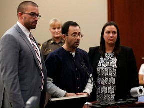 Former Michigan State University and USA Gymnastics doctor Larry Nassar (C) with defence attorneys  Matt Newberg (L) and Molly Blythe (R) during the sentencing phase in Ingham County Circuit Court on January 24, 2018 in Lansing, Michigan.  JEFF KOWALSKY/AFP/Getty Images