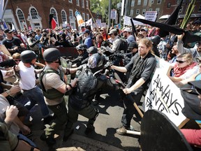 White nationalists, neo-Nazis and members of the "alt-right" clash with counter-protesters as they enter Lee Park during the "Unite the Right" rally in Charlottesville, Va., on Aug. 12, 2017.