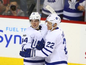 Auston Matthews and Nikita Zaitsev celebrate a Toronto Maple Leafs goal against the Calgary Flames on Nov. 28, 2017